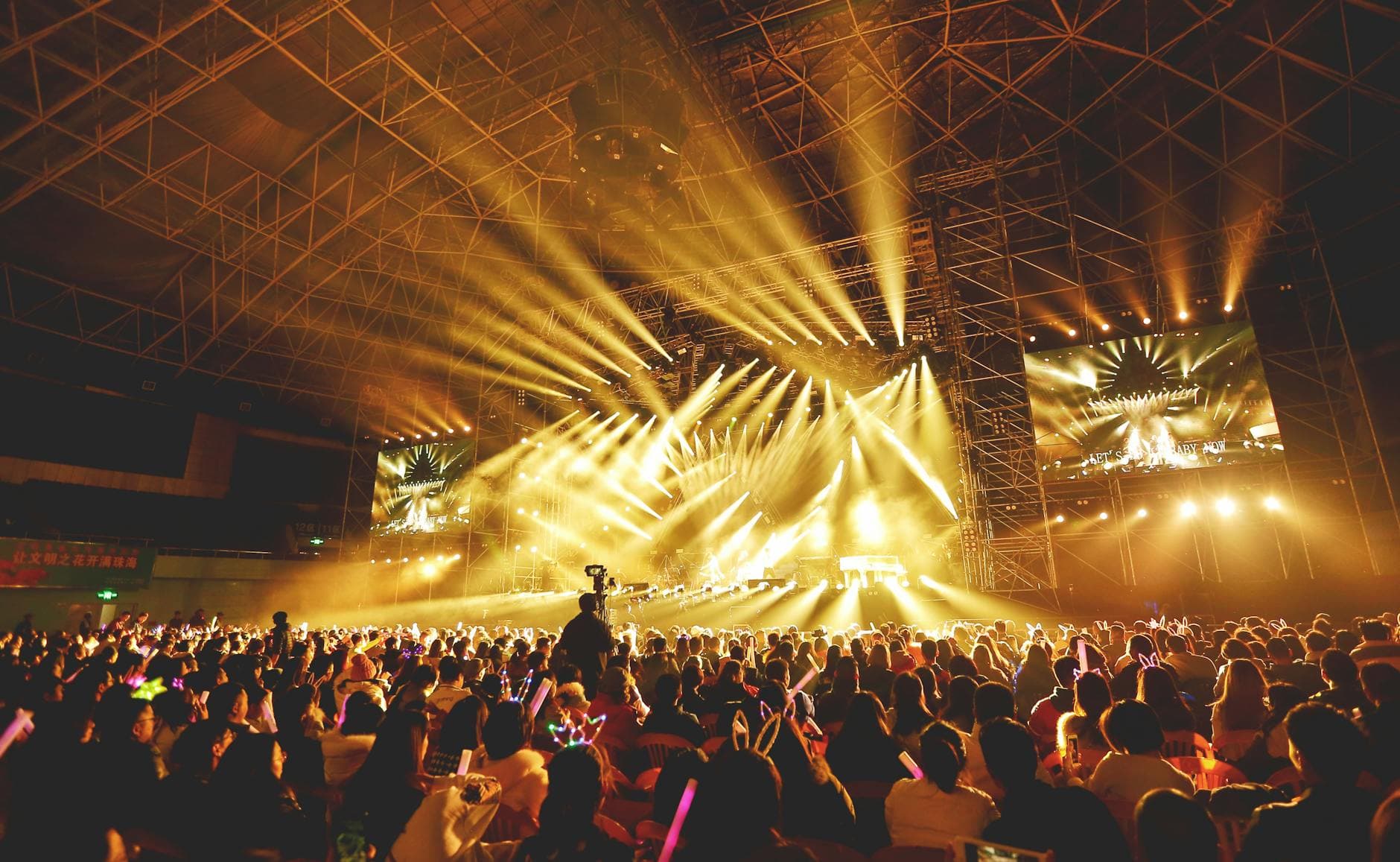 Golden beams over a live audience
